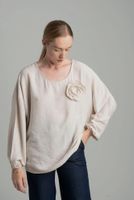 Beige oversize blouse with a decorative flower